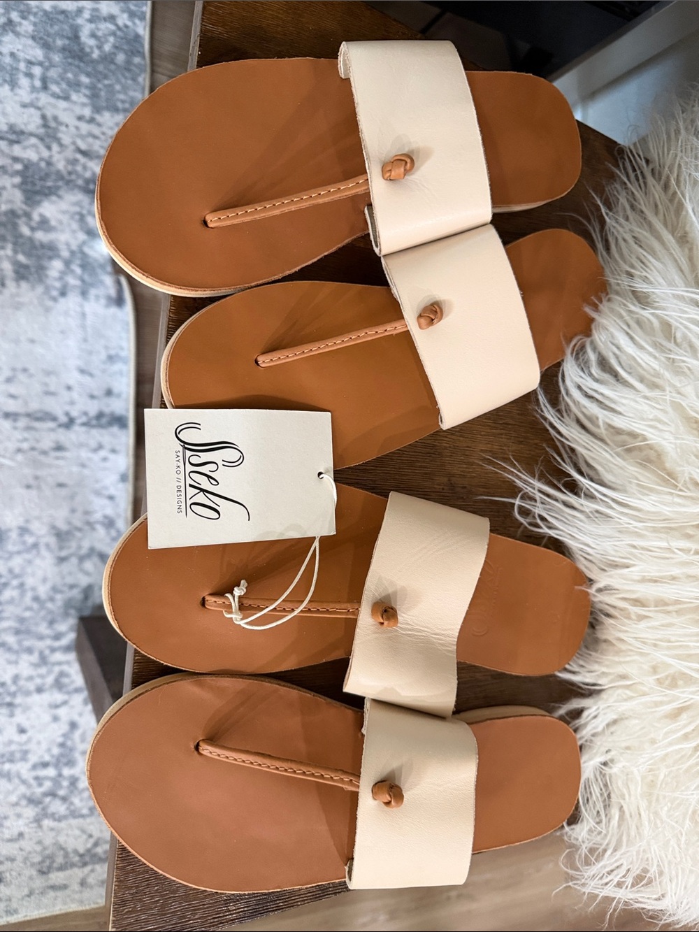 Two Pair of Sseko Cream and Tan Leather Slide Sandals